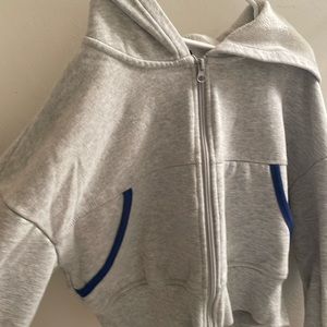 GREY PAC SUN CROPPED HOODIE WITH BLUE DETAILS ON POCKETS. LIGHTLY USED